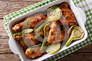 Spicy chicken baked with fennel in orange juice in a baking dish