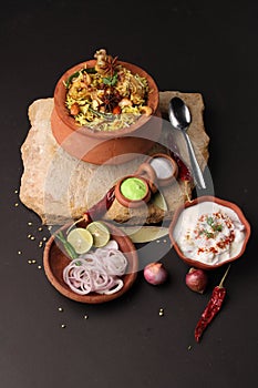 Spicy chicken biryani in traditional handi or clay pot.