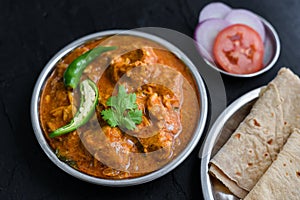 Spicy chicken curry masala, with roti popular Indian dish