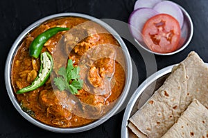 Spicy chicken curry masala, with roti popular Indian dish