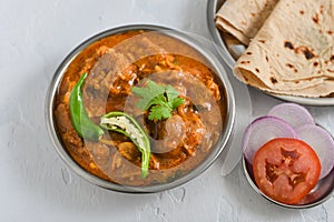 Spicy chicken curry masala, with roti popular Indian dish