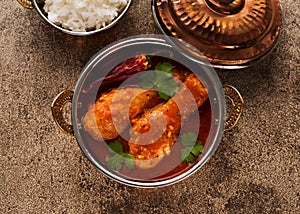 Spicy chicken legs with rice. Indian dish chicken spicy curry masala