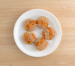 Spicy chicken salad on butter crackers on plate