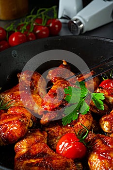 Spicy chicken wings in honey with potato wedges photo
