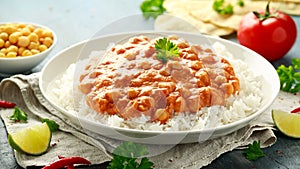 Spicy chickpeas curry with rice, tomato and Poppadoms in white plate. Healthy tasty vegetarian food