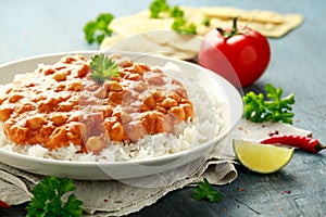 Spicy chickpeas curry with rice, tomato and Poppadoms in white plate. Healthy tasty vegetarian food