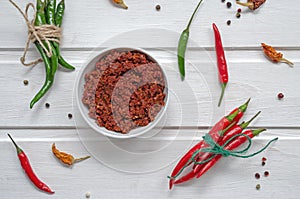 Spicy chili on a light background, flatlay. Used as an ingredient for harissa, ajika, muhammara. East and middle East kitchen