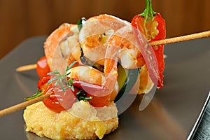 Spicy chili prawn skewers and polenta