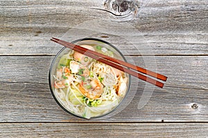 Spicy Chinese noodle soup in glass bowl