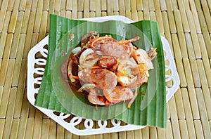 Spicy Chinese sausage salad on banana leaf