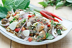 Spicy cockle salad on wooden background