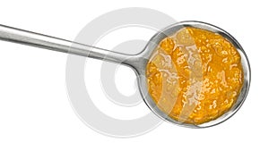 Spicy cream soup in spoon isolated on white background, top view