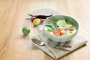 Spicy creamy coconut soup with chicken , Thai food called Tom Kha Gai on the wooden table photo