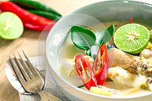 Spicy creamy coconut soup with chicken , Thai food called Tom Kha Gai on the wooden table