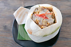 Spicy curry streamed seafood in young coconut cup called Hor mok in Thai