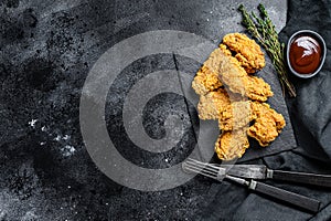 Spicy Deep Fried Breaded Chicken Wings. Black background. Top view. Copy space