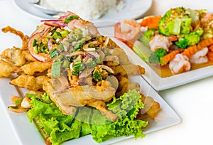 Spicy deep fried squid mingle serve with broccoli prawn salad. A