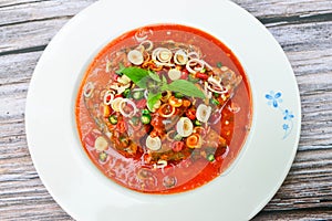 Spicy fish Canned Sardines Salad .with spices lime,canned fish in tomato sauce on wooden background.
