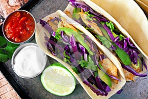 Spicy fish tacos with red cabbage slaw, overhead view