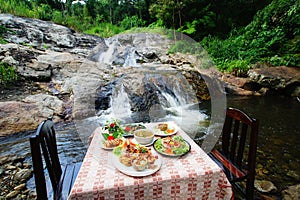 Spicy food set at waterfall