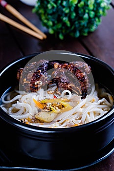 Spicy fried pork spareribs with thick rice noodles soup