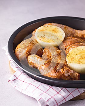 Spicy Glazed Chicken Legs on Black Plate Ready to Cook Homemade Food Concept for a Tasty and Healthy Dish. Gray Background Top