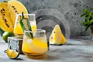 Spicy golden watermelon margarita cocktail with jalapeno and lime.