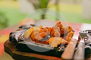 spicy hot chicken steak with sausage and knife