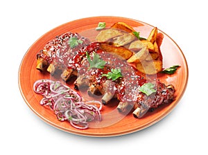 Spicy hot grilled pork ribs served with a pickled onion and fried potato on orange plate isolated on white background