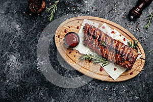 Spicy hot grilled spare ribs BBQ served on wooden cutting board, banner, menu, recipe place for text, top view