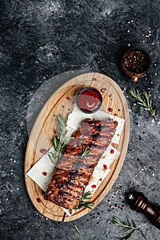 Spicy hot grilled spare ribs BBQ served on wooden cutting board, banner, menu, recipe place for text, top view