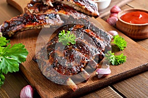 Spicy hot grilled spare ribs on cutting board