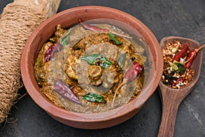 Spicy Indian chicken curry of Chettinad in clay pot