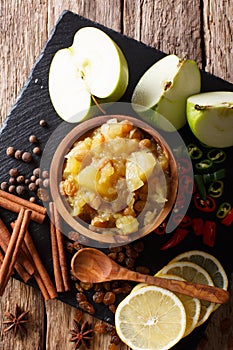 Spicy Indian sauce - apple chutney with lemon close-up in a bowl