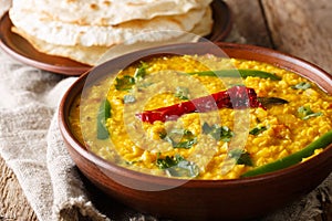 Spicy Indian thick soup Dal Tadka is a popular North Indian recipe close up in a bowl. Horizontal