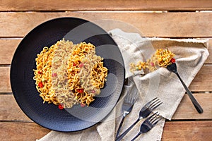 Spicy indonesian fried noodle with fork and napkin