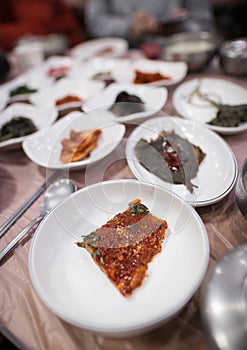 A spicy Korean side dish is served on a white dish.