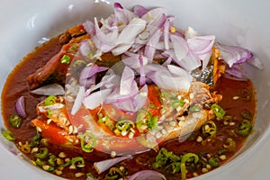 Spicy mackerels salad in tomato sauce .Thai cooking,dark tone .