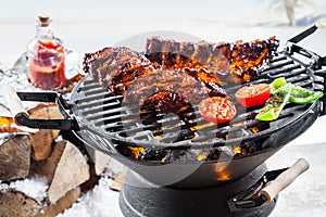 Spicy marinated spare ribs grilling outdoors