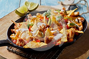 Spicy Mexican chicken with nachos and cream