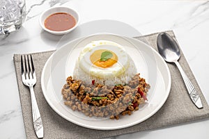 Spicy minced pork pad kra pao served with plain cooked rice and fried egg