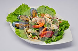 Spicy mixed seafood salad Yum Talay on white plate