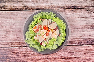 Spicy mixed vegetable salad with sliced Thai white pork sausage