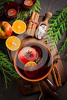 Spicy mulled wine with orange, apple, cinnamon and anise in pot