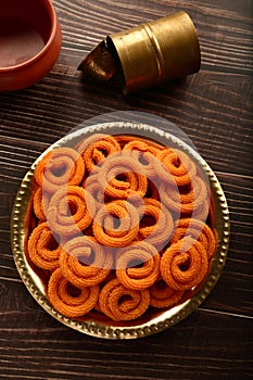 Spicy  murukku or chakli. served in brass plate.