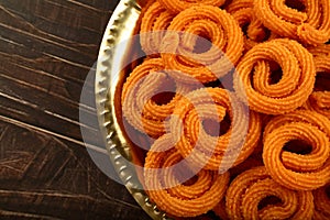 Spicy  murukku or chakli. served in brass plate.