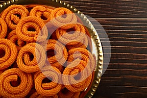 Spicy  murukku or chakli. served in brass plate.