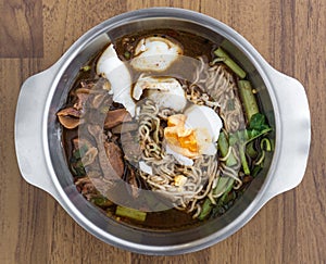 Spicy noodle meat soup, traditional Thai food, in stainless bowl