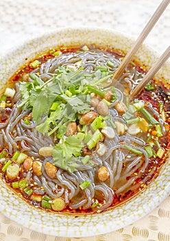 Spicy noodle soup with vegetables, herbs, peanuts and coriander.