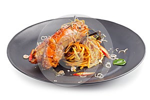 Spicy Pasta with seafood with herbs and spices in Black dish iso